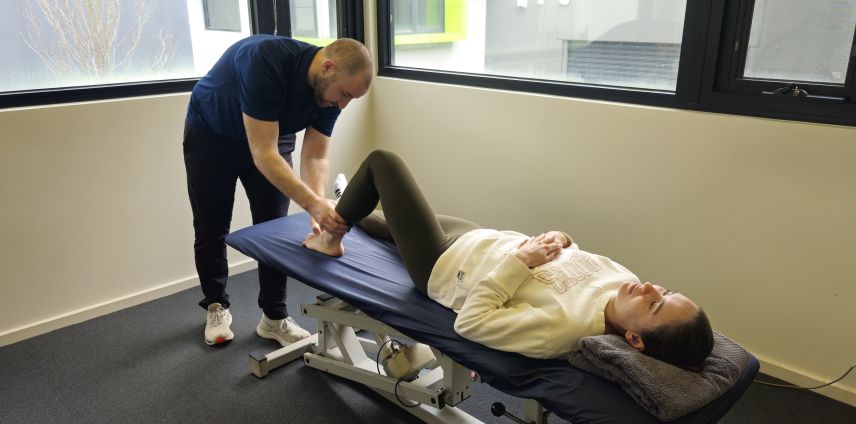 PPhysiotherapist assessing a patient's ankle for a sports injury at Adapt Sports Physiotherapy, Chirnside Park