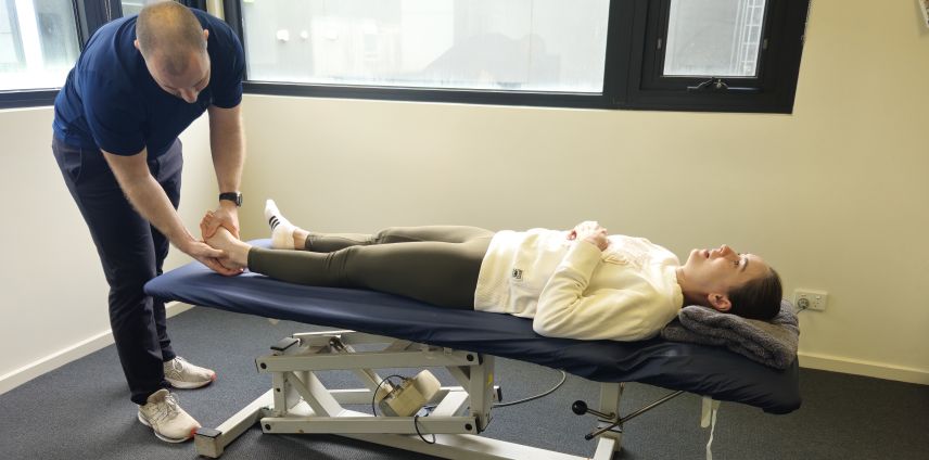 Physiotherapist assessing shin splints in a runner's lower leg